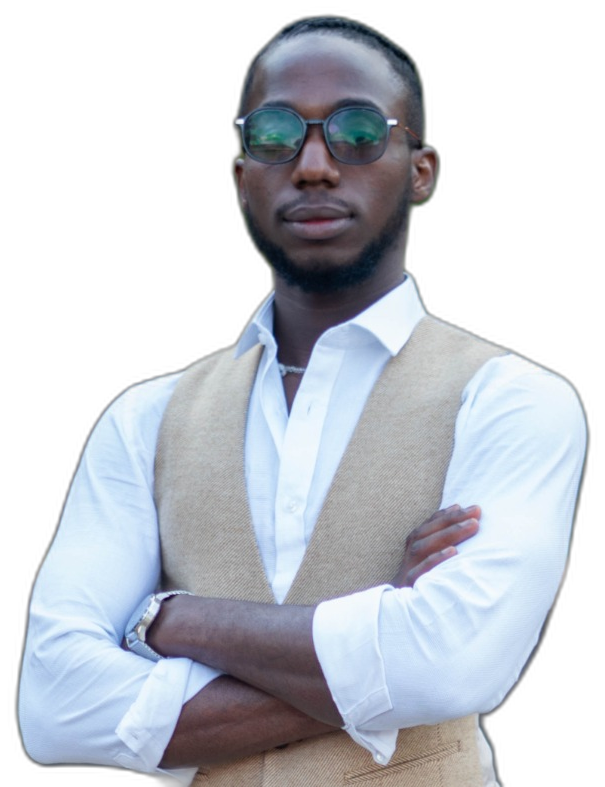 Shammah Omoniyi, arms crossed, in a white shirt and cream waistcoat